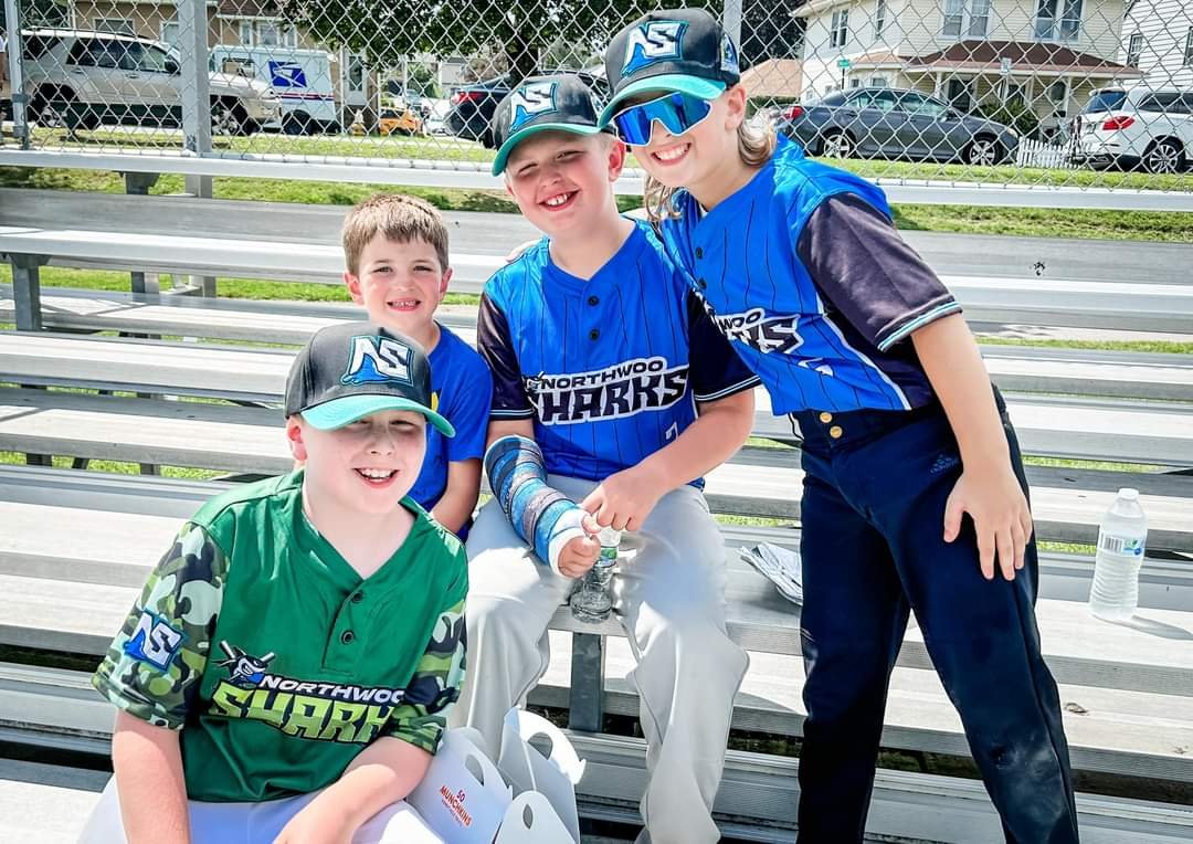 Young Northwoods Sharks baseball players smiling in custom Capra jerseys