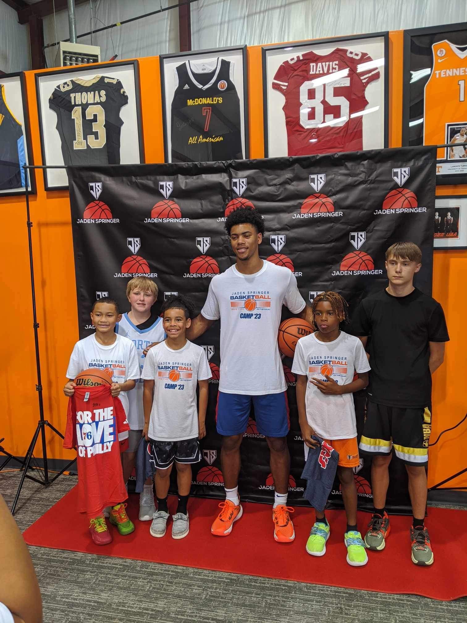 Youth basketball players in custom Capra gear at a basketball camp
