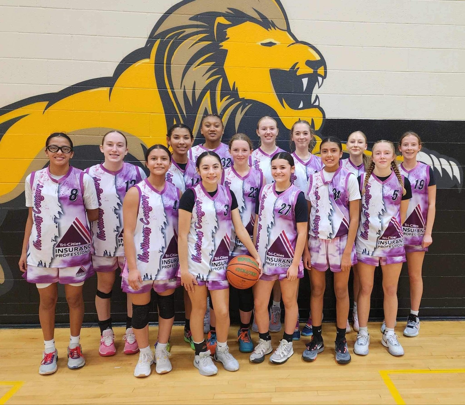 Girls basketball team in custom purple Capra uniforms