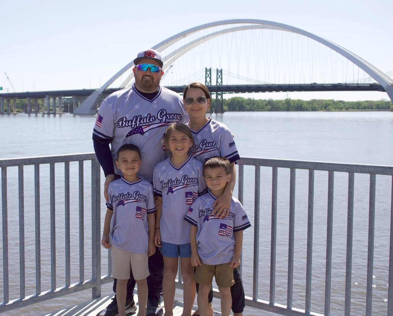 Family in custom Buffalo Grove Capra baseball jerseys by the river