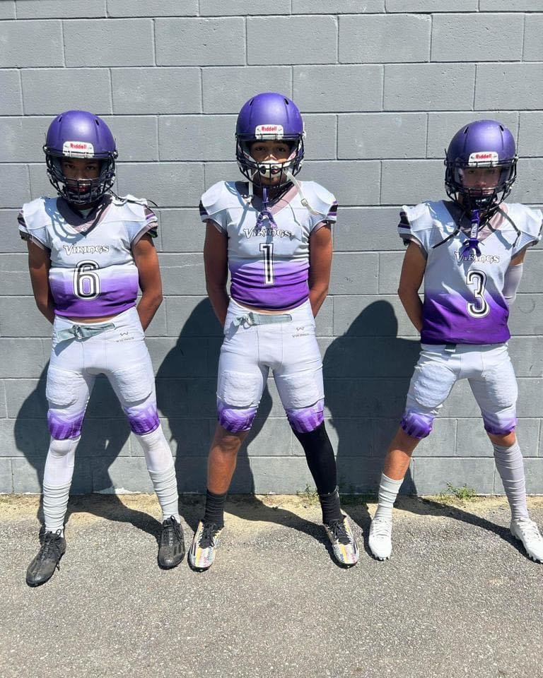 Worcester Vikings youth football players in custom purple and white Capra uniforms