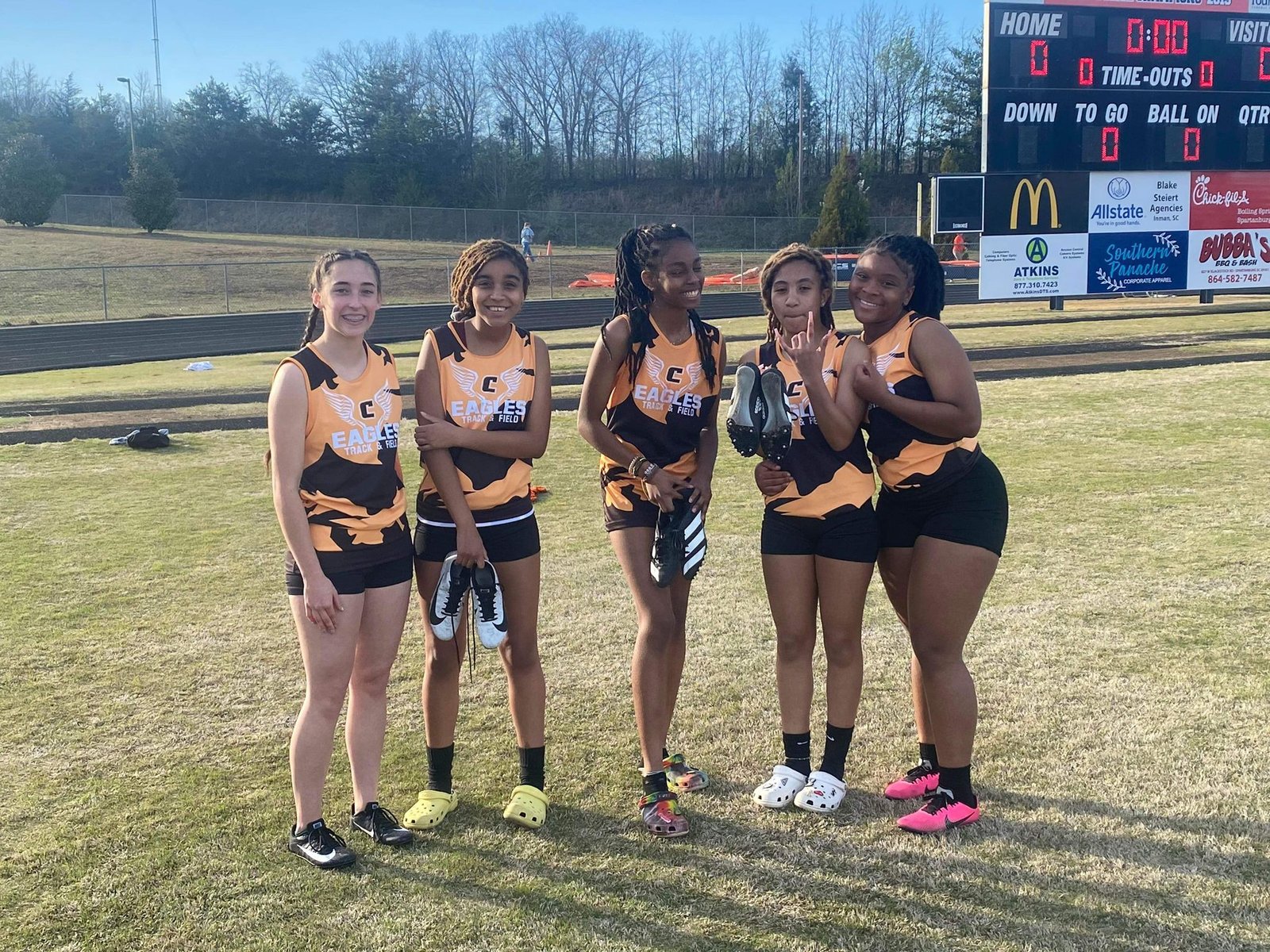 Girls flag football team in custom black and orange Eagles Capra uniforms