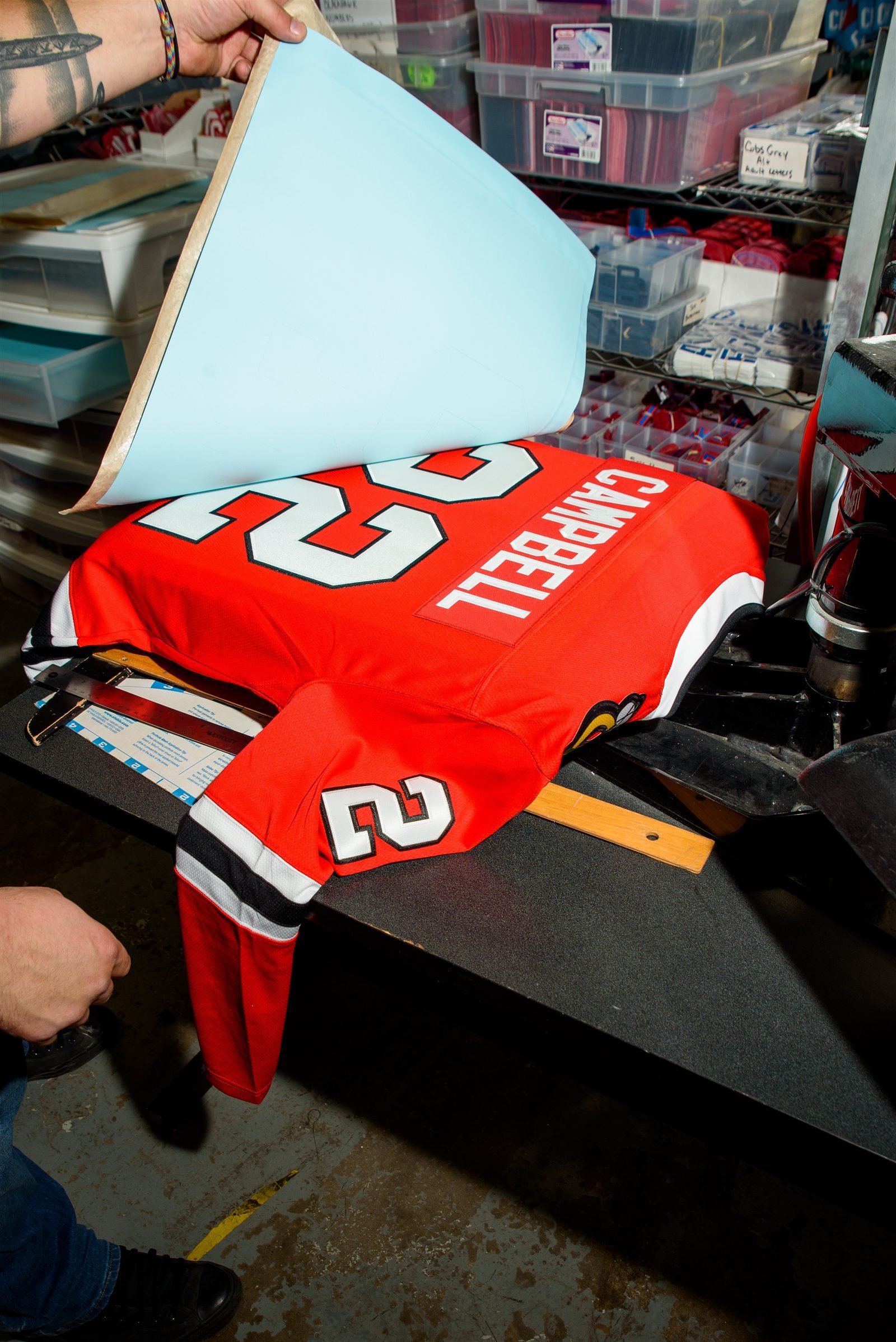 Heat transfer film being peeled off a finished pre-made team jersey