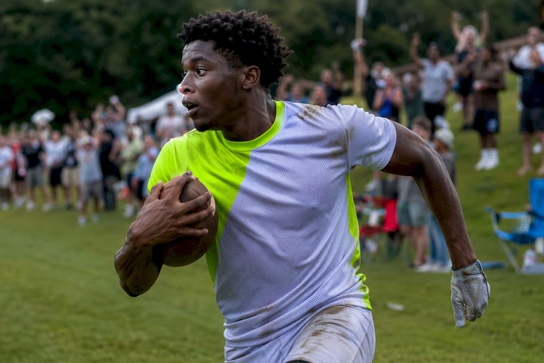 Football player in colorblock jersey running on field