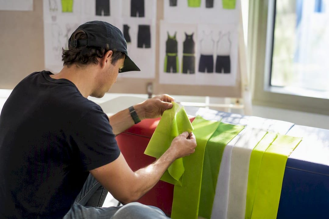 Designer inspecting printed basketball fabric swatches