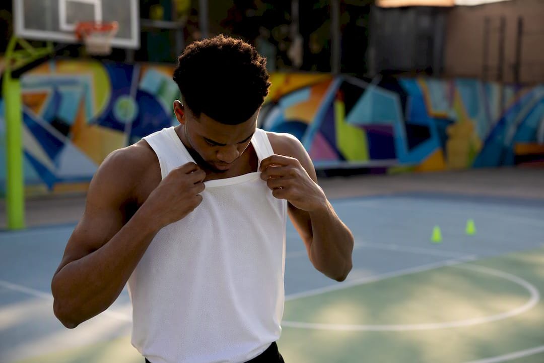 Athlete adjusting basketball jersey sample fit