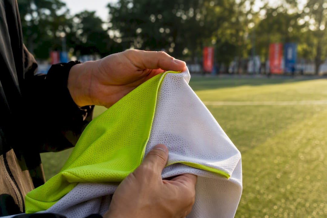 Hands examining reversible jersey fabric layers