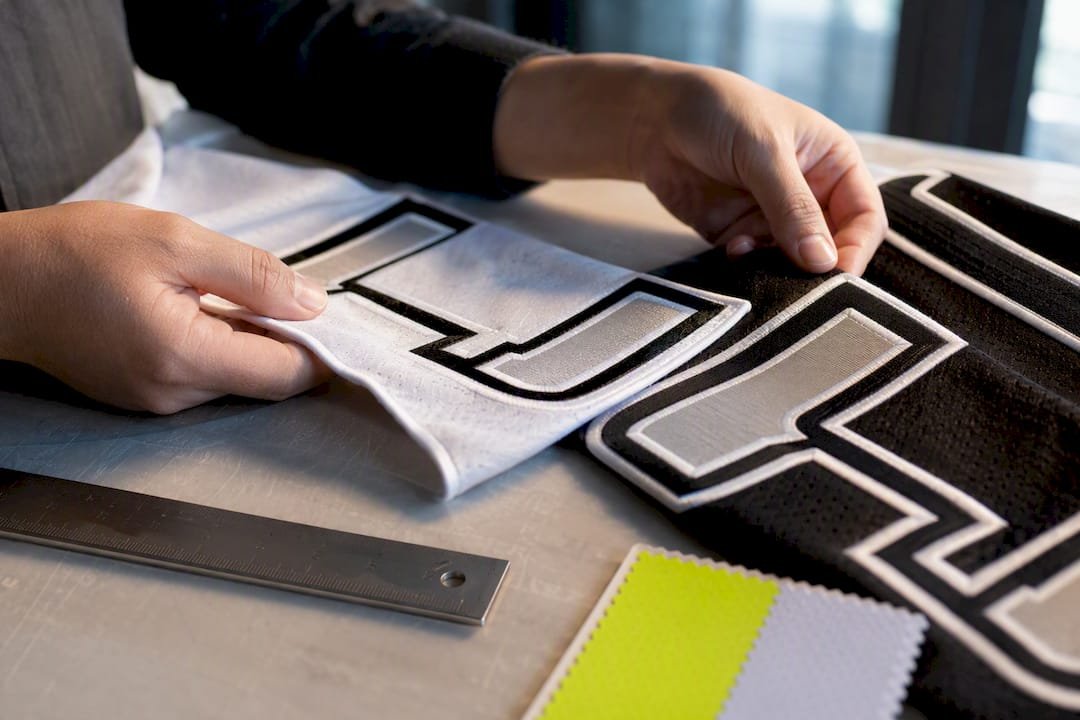 Close-up of outlined athletic lettering on fabric