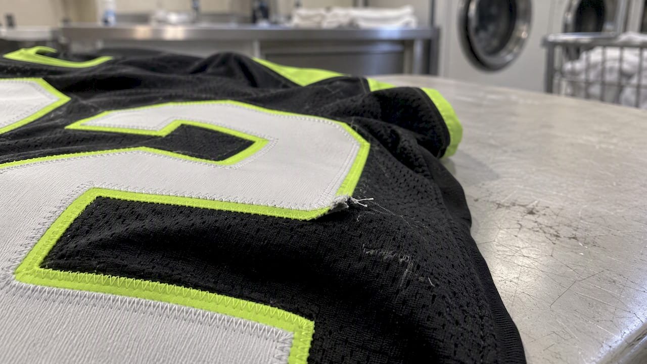 Loose stitching along a tackle-twill jersey number